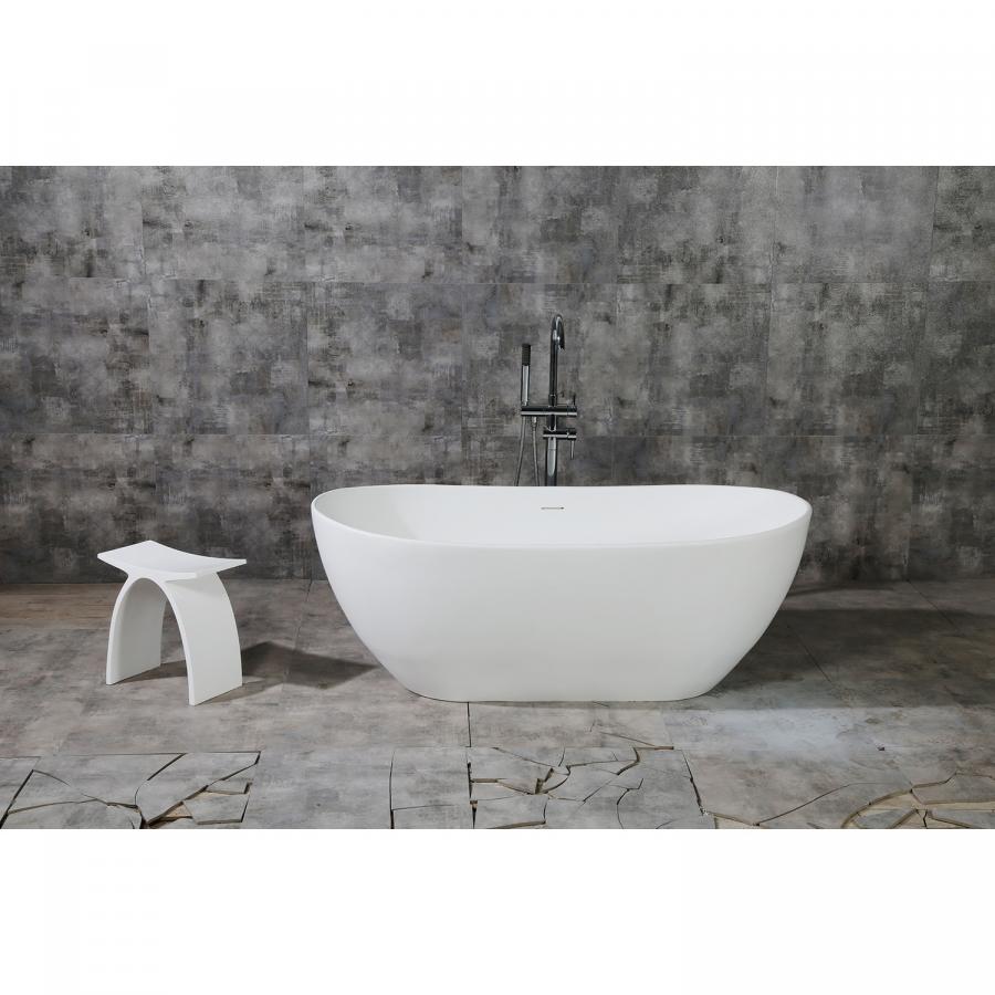 Matte white solid surface stone freestanding tub in a calm, softly lit modern bathroom